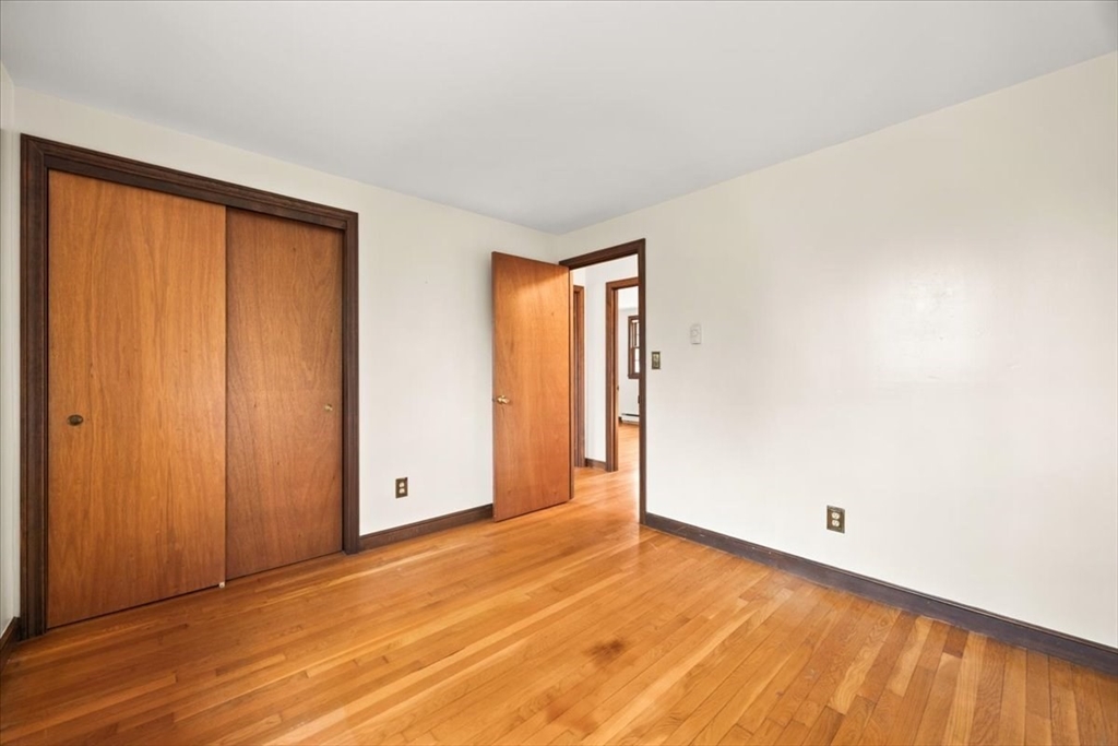 37 Woodlock Road Hingham, MA 02043 - Photo 23 of 34 an empty room with wooden floor and windows
