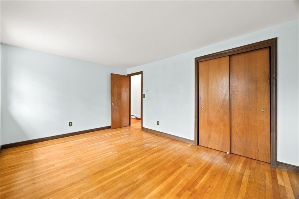37 Woodlock Road Hingham, MA 02043 - Photo 26 of 34 a view of an empty room with wooden floor and a window