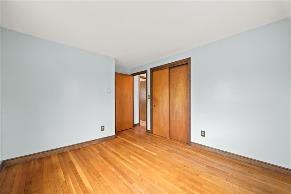 37 Woodlock Road Hingham, MA 02043 - Photo 28 of 34 a view of an empty room with wooden floor and a window