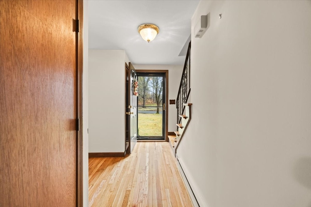 37 Woodlock Road Hingham, MA 02043 - Photo 7 of 34 a view of a livingroom from a hallway