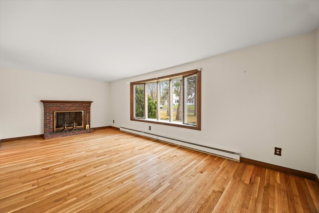 37 Woodlock Road Hingham, MA 02043 - Photo 8 of 34 a view of an empty room with wooden floor and a window