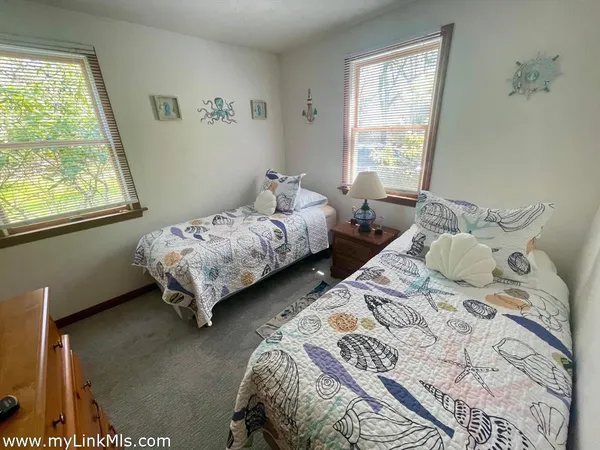 a bedroom with two beds and a window