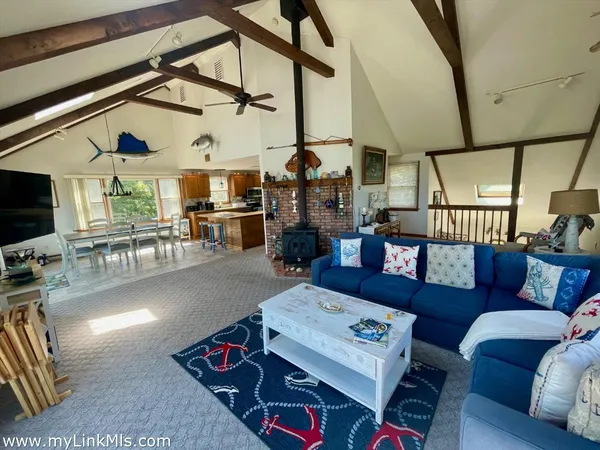 a living room with furniture a flat screen tv and a table