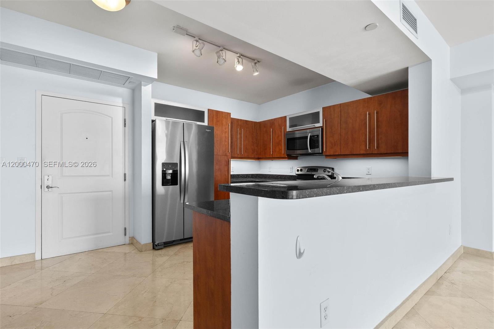 7350 Southwest 89th Street, Unit 1707S Miami, FL 33156 - Photo 35 of 45 a kitchen with stainless steel appliances granite countertop a refrigerator and a stove