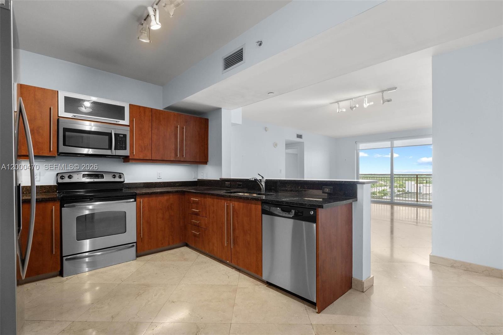 7350 Southwest 89th Street, Unit 1707S Miami, FL 33156 - Photo 37 of 45 a kitchen with stainless steel appliances a stove a sink and a microwave