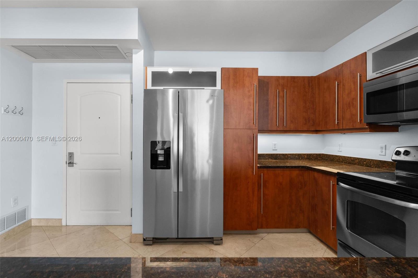 7350 Southwest 89th Street, Unit 1707S Miami, FL 33156 - Photo 38 of 45 a kitchen with stainless steel appliances granite countertop a refrigerator and a stove top oven