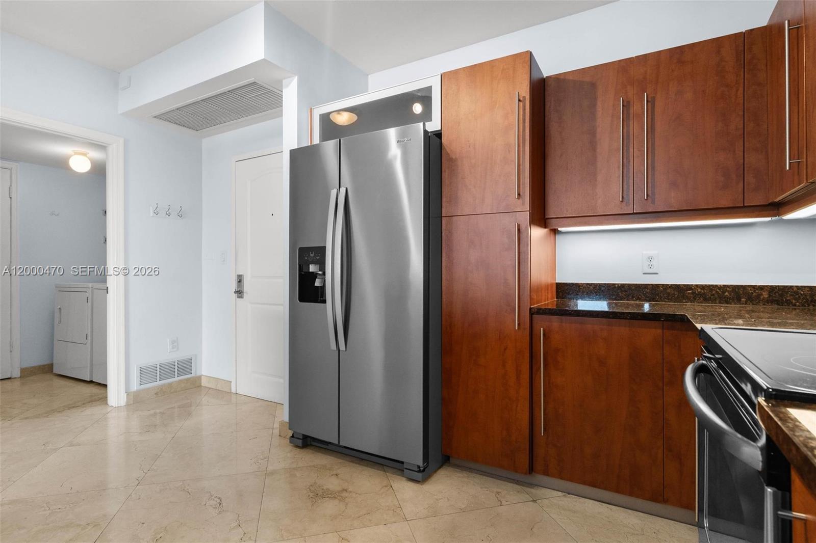 7350 Southwest 89th Street, Unit 1707S Miami, FL 33156 - Photo 39 of 45 a kitchen with stainless steel appliances granite countertop a refrigerator and a sink