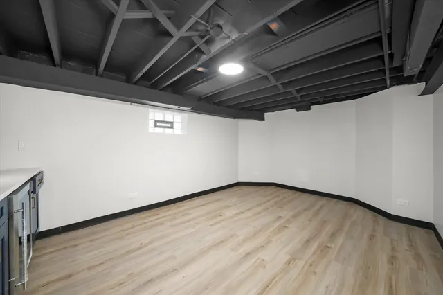 a view of storage and utility room with wooden floor