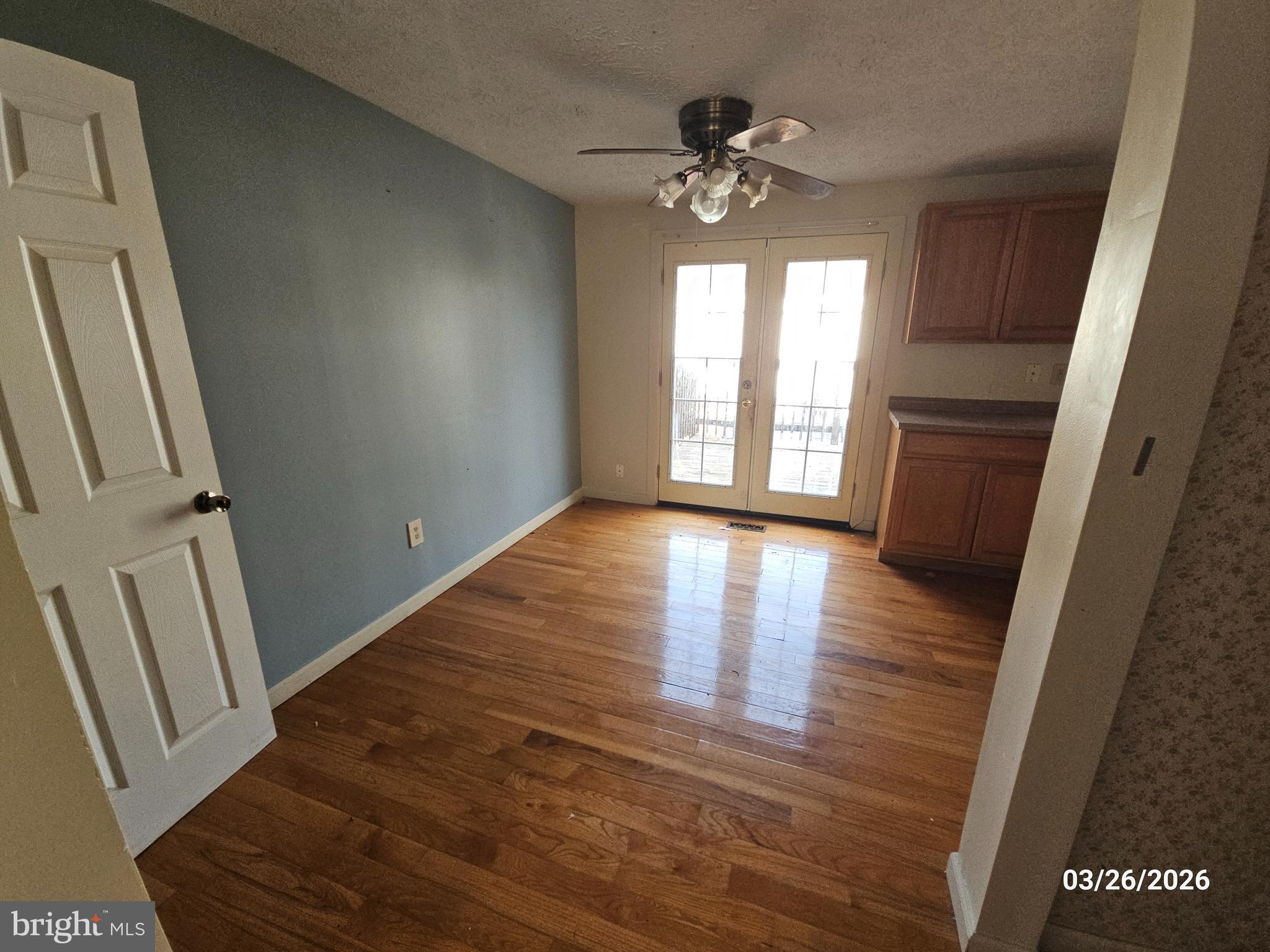 1234 Elm Grove Circle Silver Spring, MD 20905 - Photo 3 of 8 a view of an empty room with wooden floor and a window