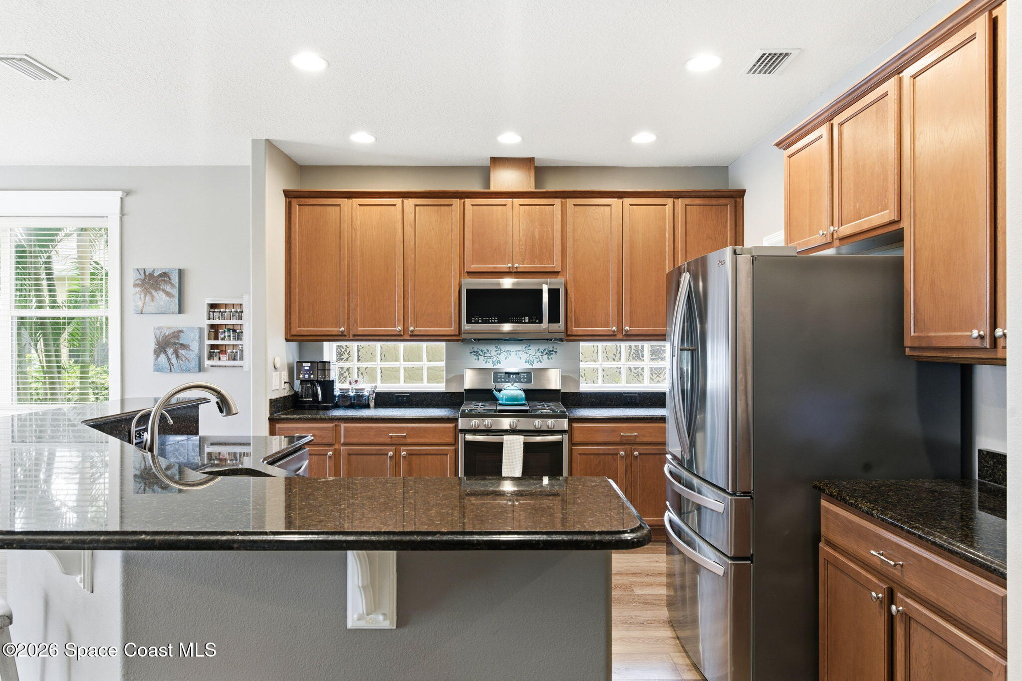 3283 Candia Drive Melbourne, FL 32940 - Photo 15 of 45 a kitchen with a refrigerator and a sink