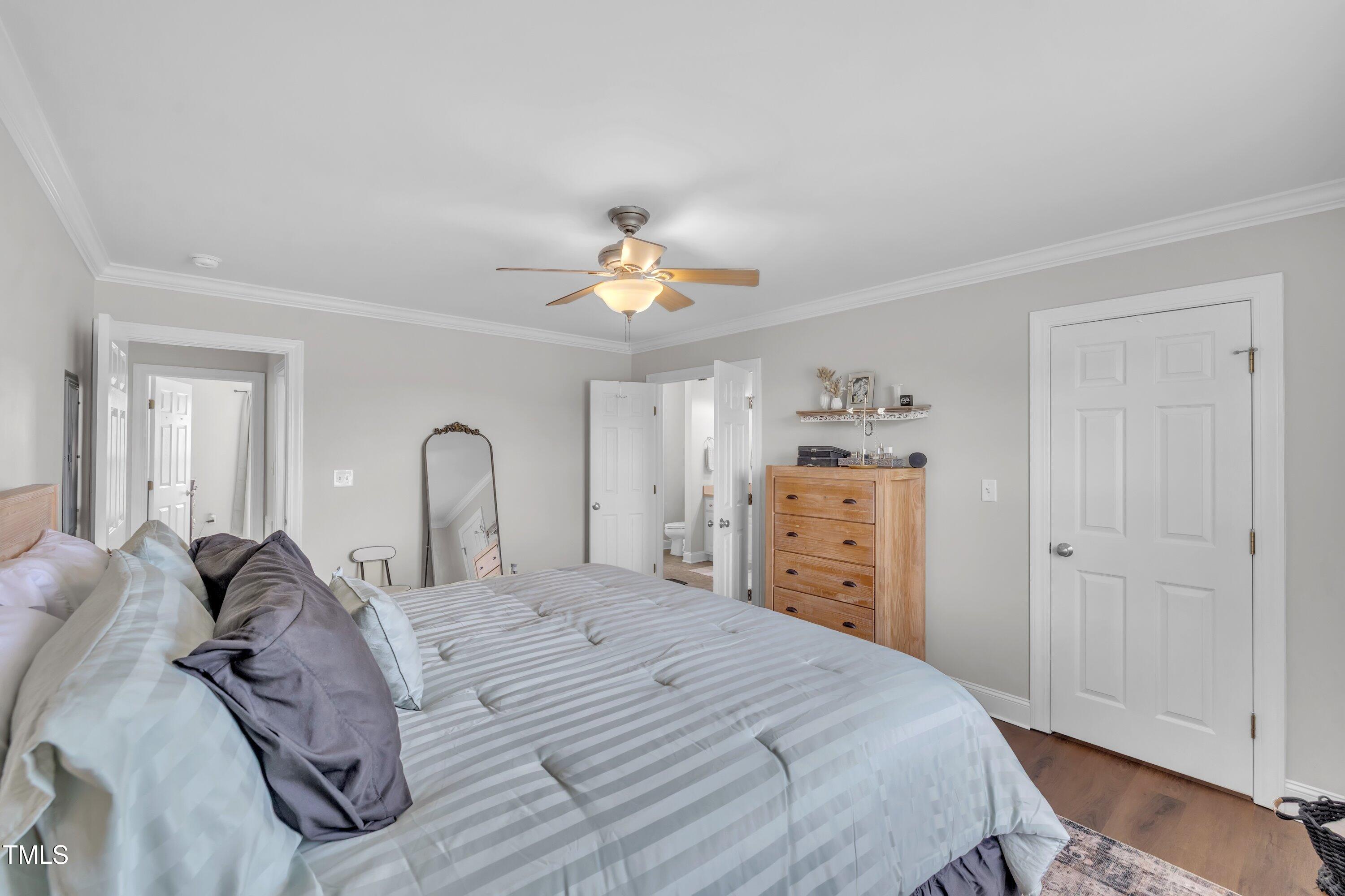 6953 Rock Ridge Sims Road Sims, NC 27880 - Photo 16 of 29 a bedroom with a bed and a chandelier