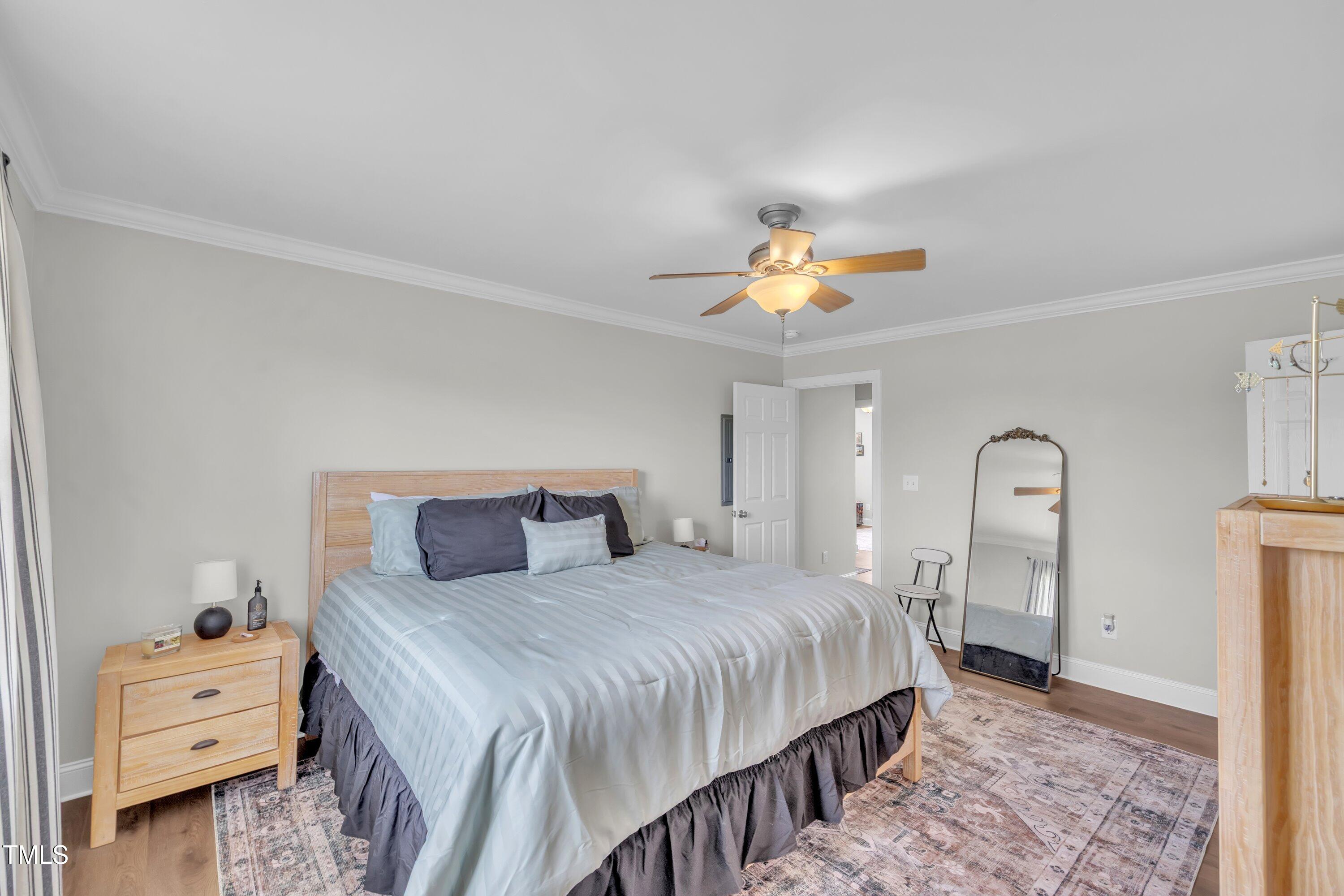 6953 Rock Ridge Sims Road Sims, NC 27880 - Photo 17 of 29 a bedroom with a bed and a chandelier