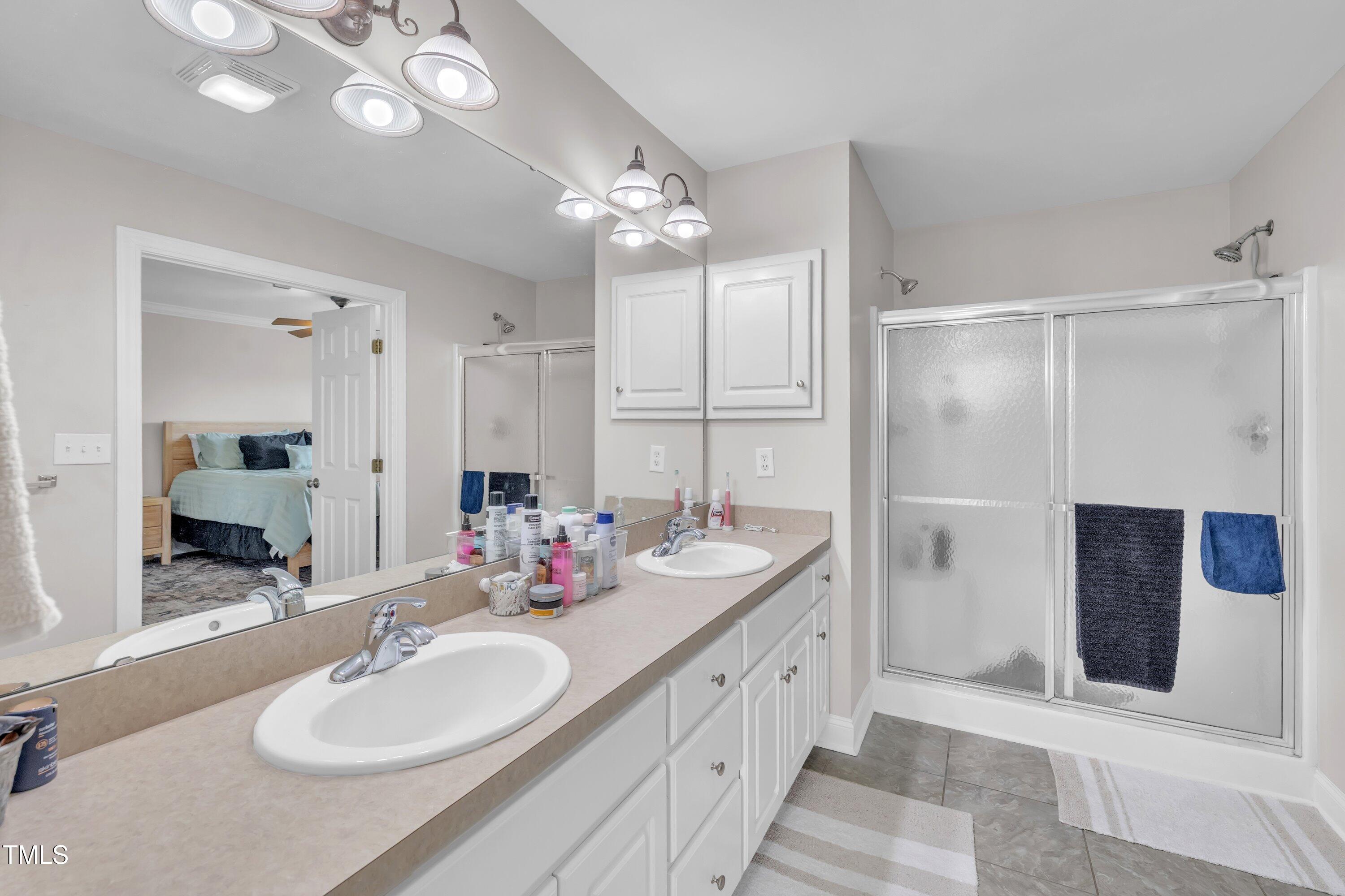 6953 Rock Ridge Sims Road Sims, NC 27880 - Photo 18 of 29 a bathroom with a double vanity sink mirror and double