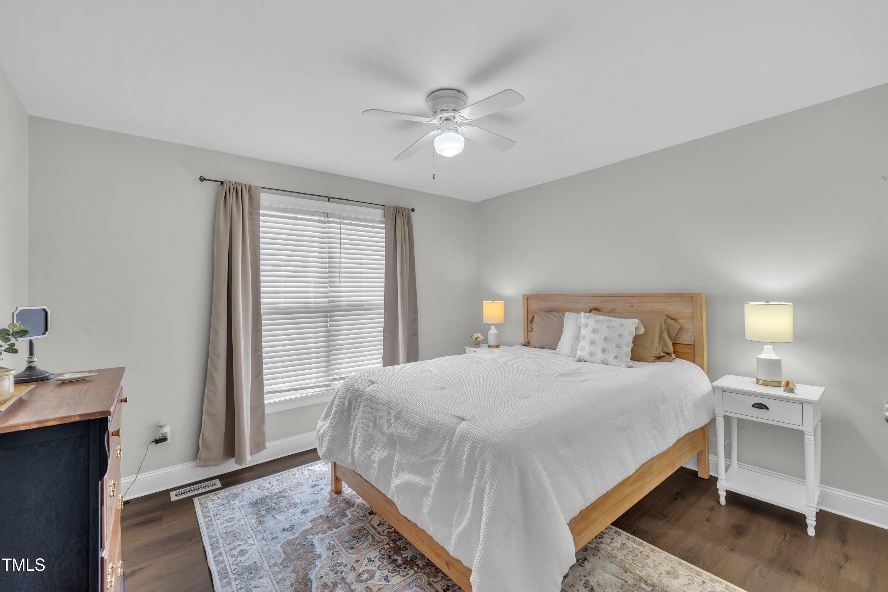 6953 Rock Ridge Sims Road Sims, NC 27880 - Photo 19 of 29 a bedroom with a bed and a chandelier
