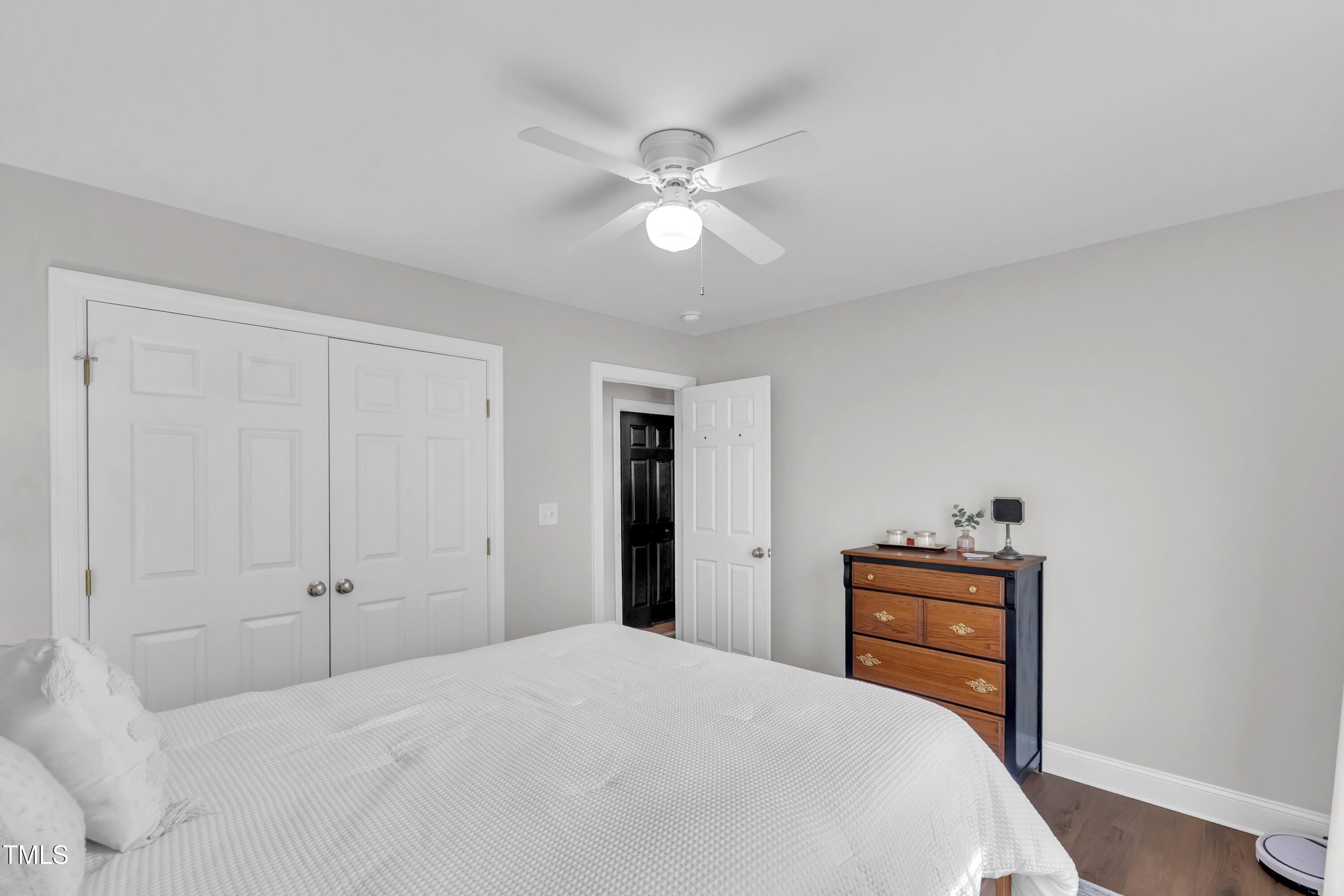 6953 Rock Ridge Sims Road Sims, NC 27880 - Photo 20 of 29 a bedroom with a bed and a chandelier