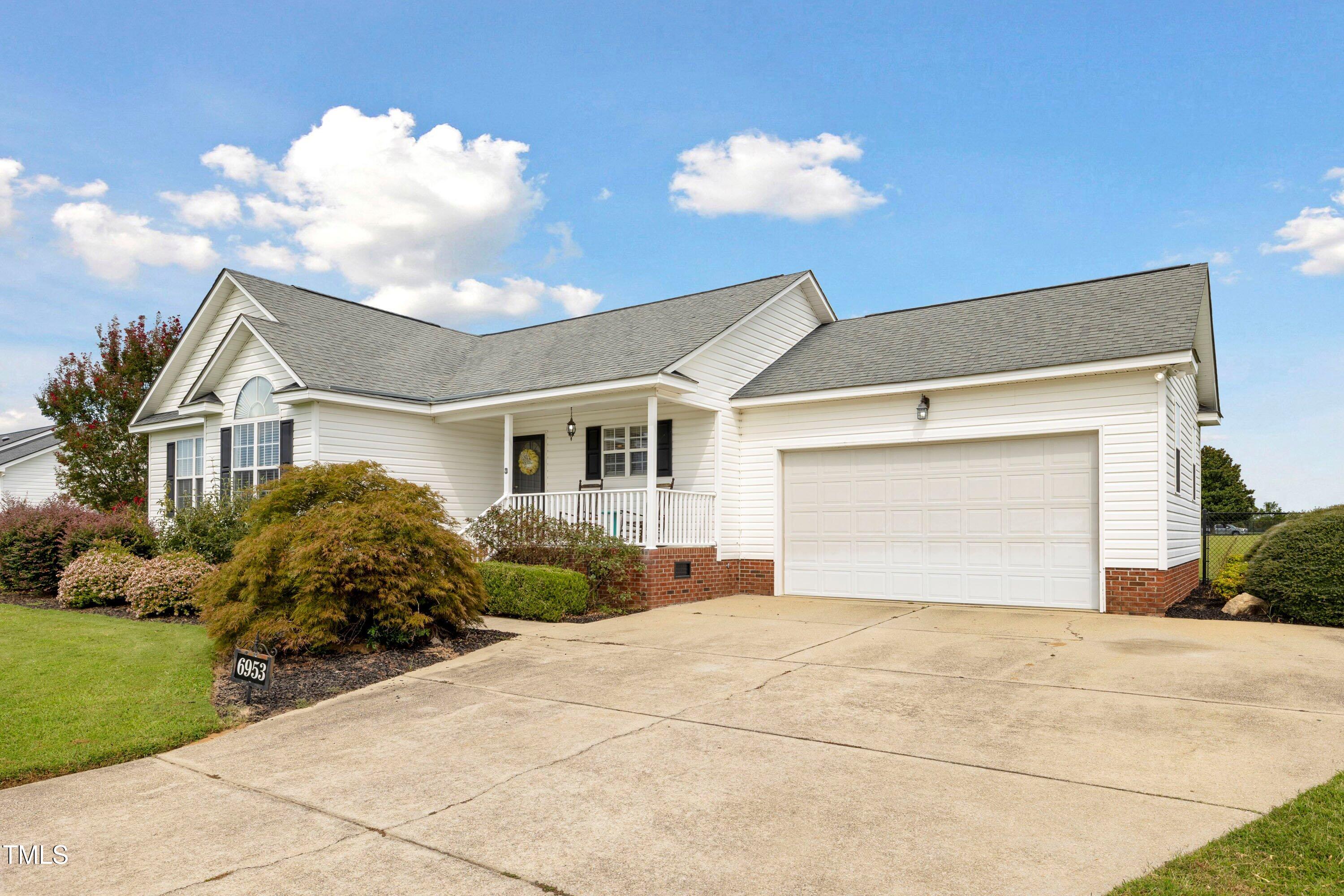 6953 Rock Ridge Sims Road Sims, NC 27880 - Photo 2 of 29 a front view of a house with a yard and garage