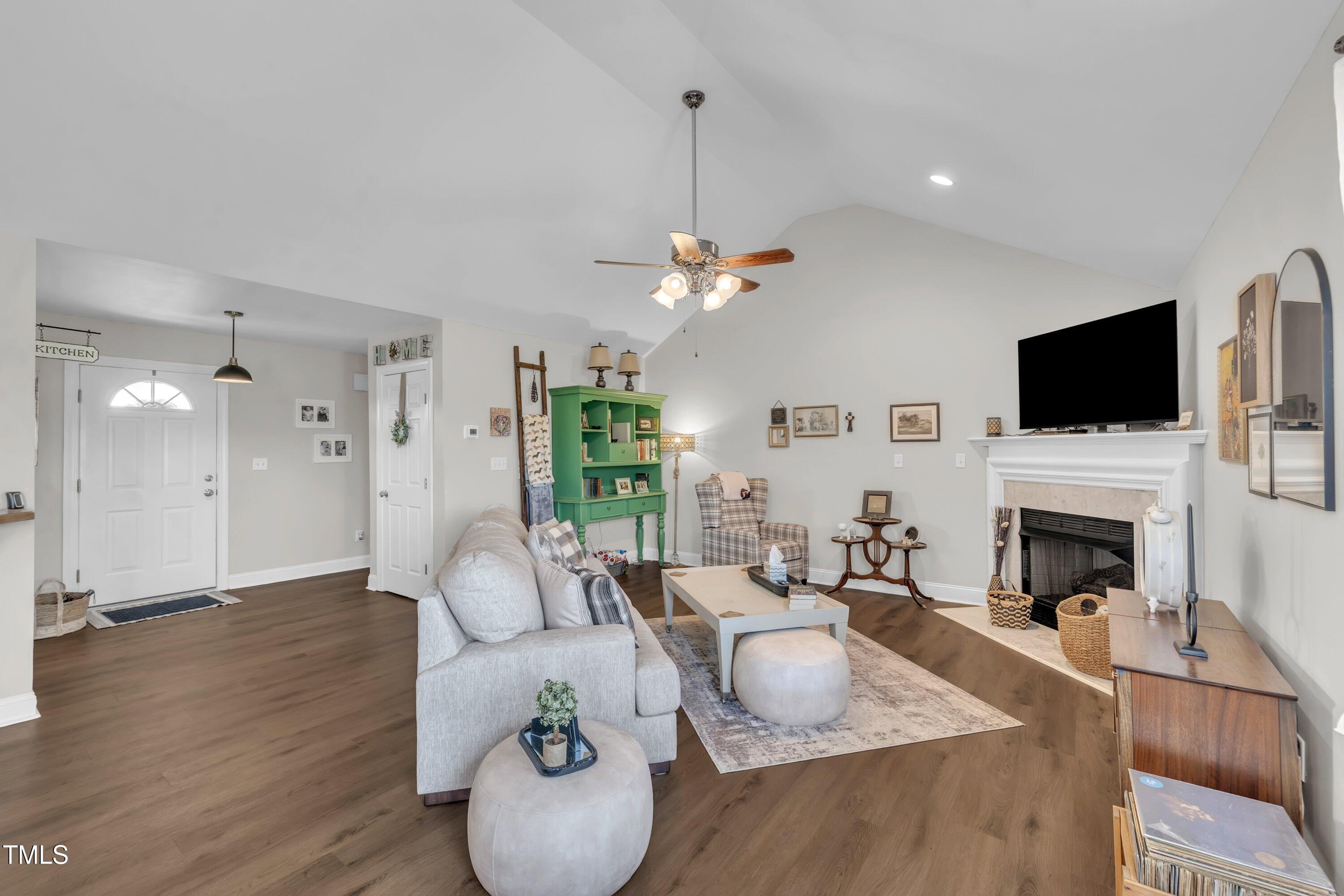 6953 Rock Ridge Sims Road Sims, NC 27880 - Photo 4 of 29 a living room with furniture a fireplace and a flat screen tv