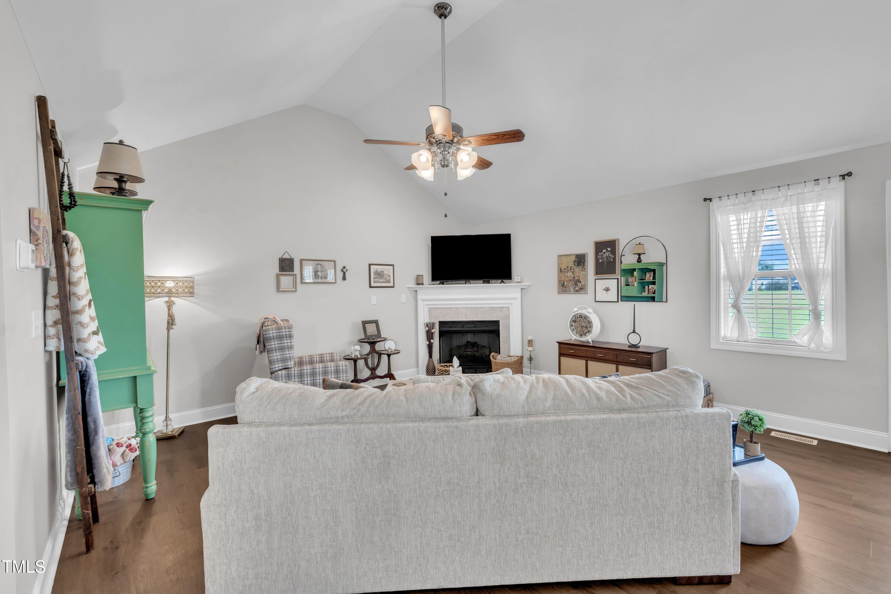 6953 Rock Ridge Sims Road Sims, NC 27880 - Photo 5 of 29 a living room with furniture a fireplace and a flat screen tv