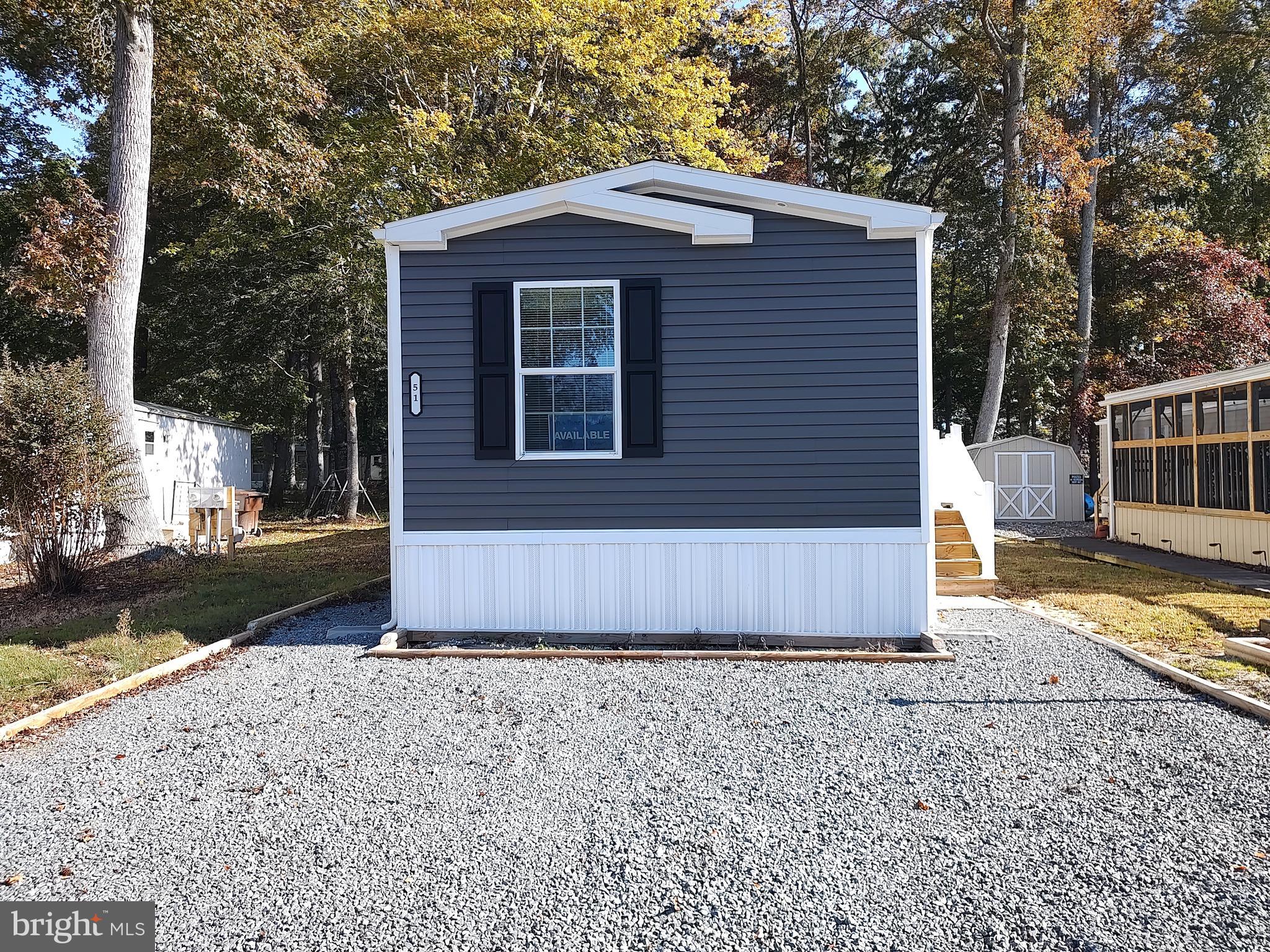 12623 Shell Mill Road, Unit 51 Bishopville, MD 21813 - Photo 11 of 41 a front view of a house with a yard