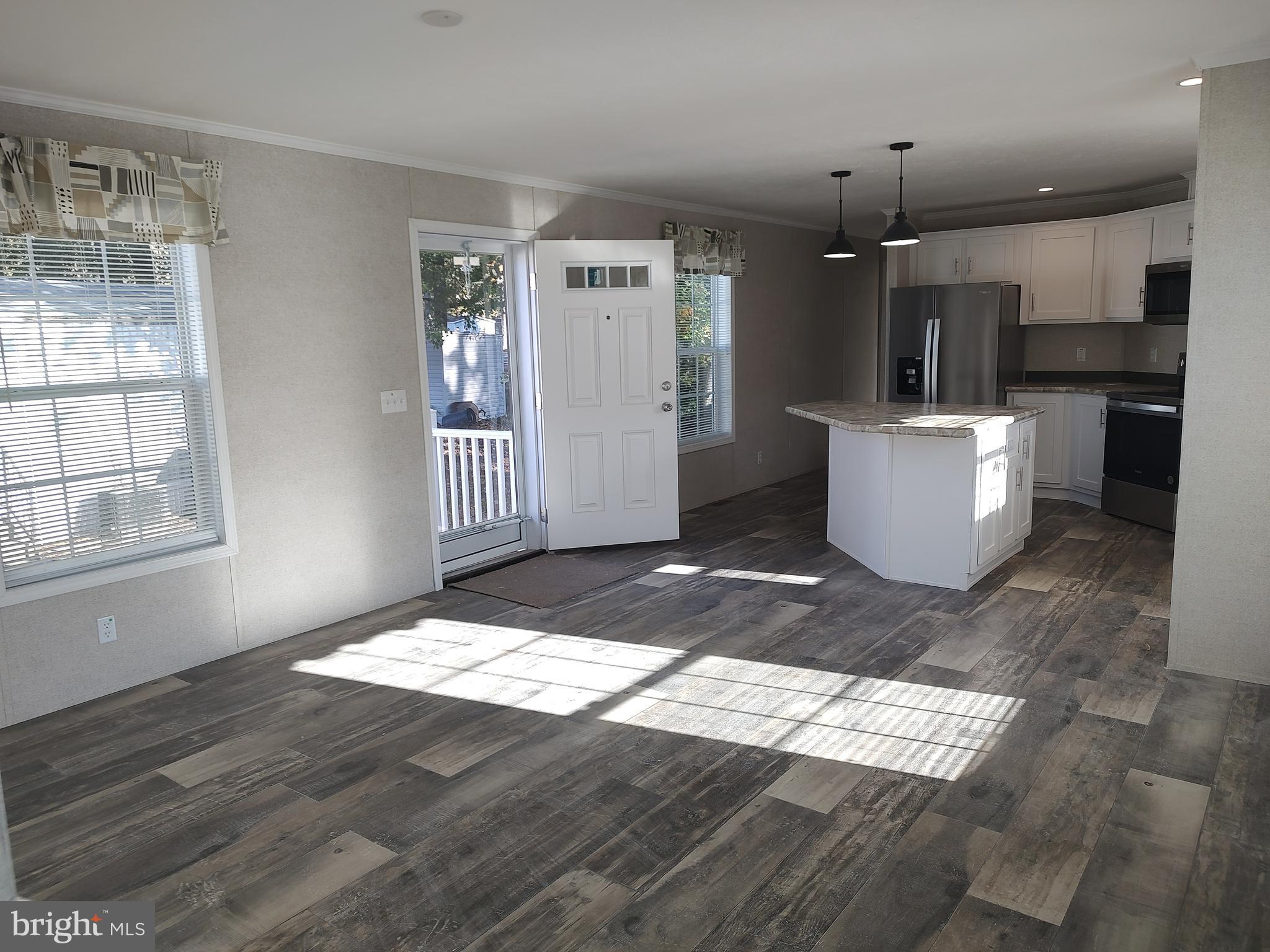 12623 Shell Mill Road, Unit 51 Bishopville, MD 21813 - Photo 12 of 41 a view of kitchen and hall with wooden floor