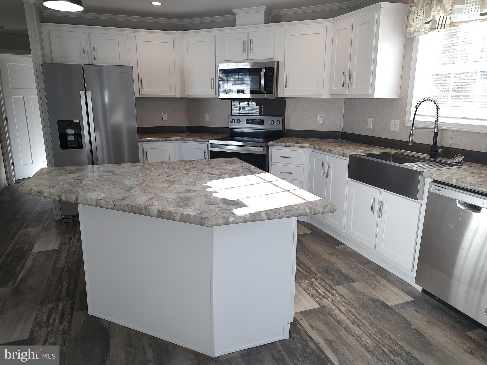 12623 Shell Mill Road, Unit 51 Bishopville, MD 21813 - Photo 18 of 41 a kitchen with stainless steel appliances granite countertop a sink stove and refrigerator