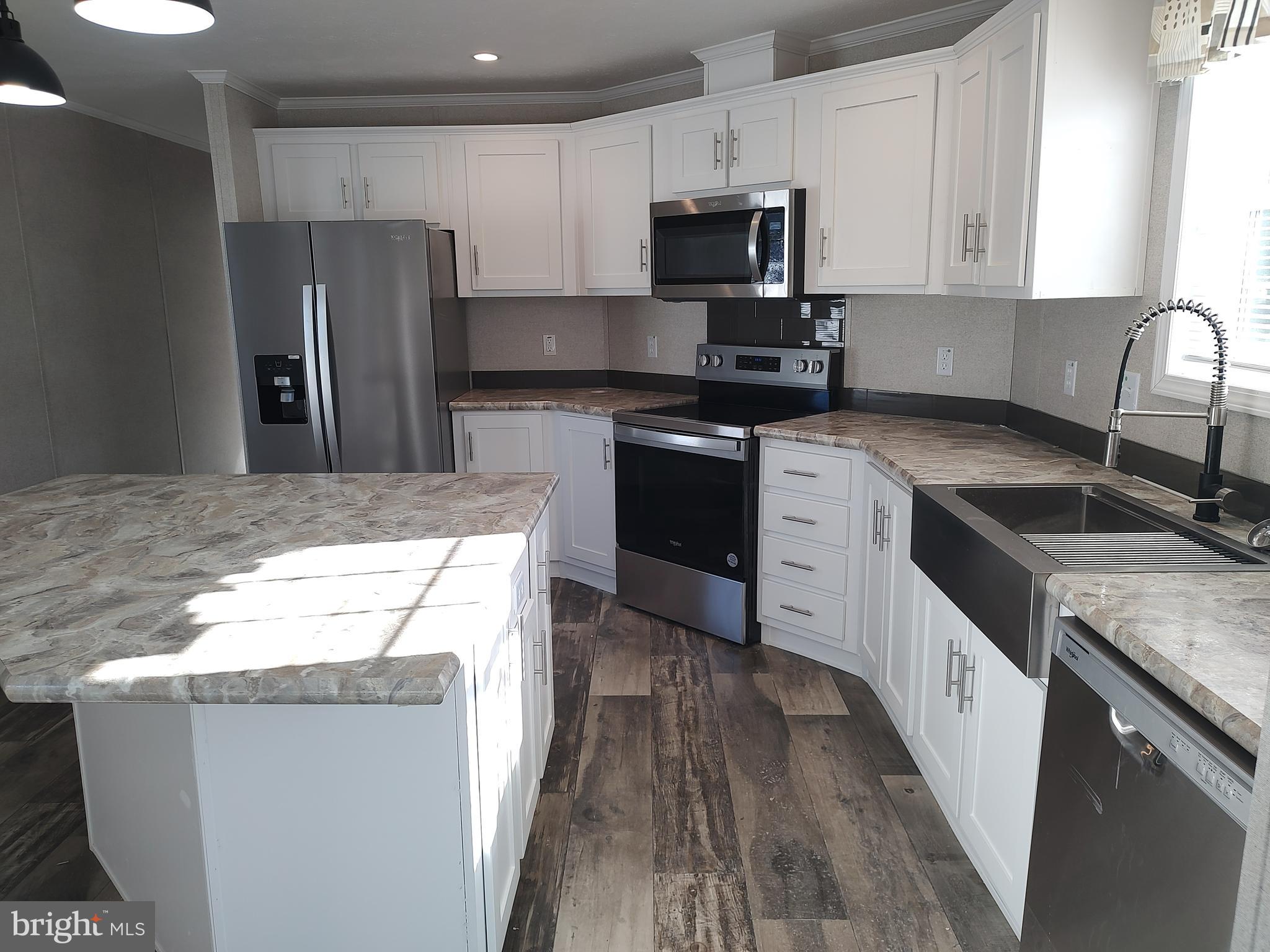 12623 Shell Mill Road, Unit 51 Bishopville, MD 21813 - Photo 22 of 41 a kitchen with granite countertop a sink stove and refrigerator