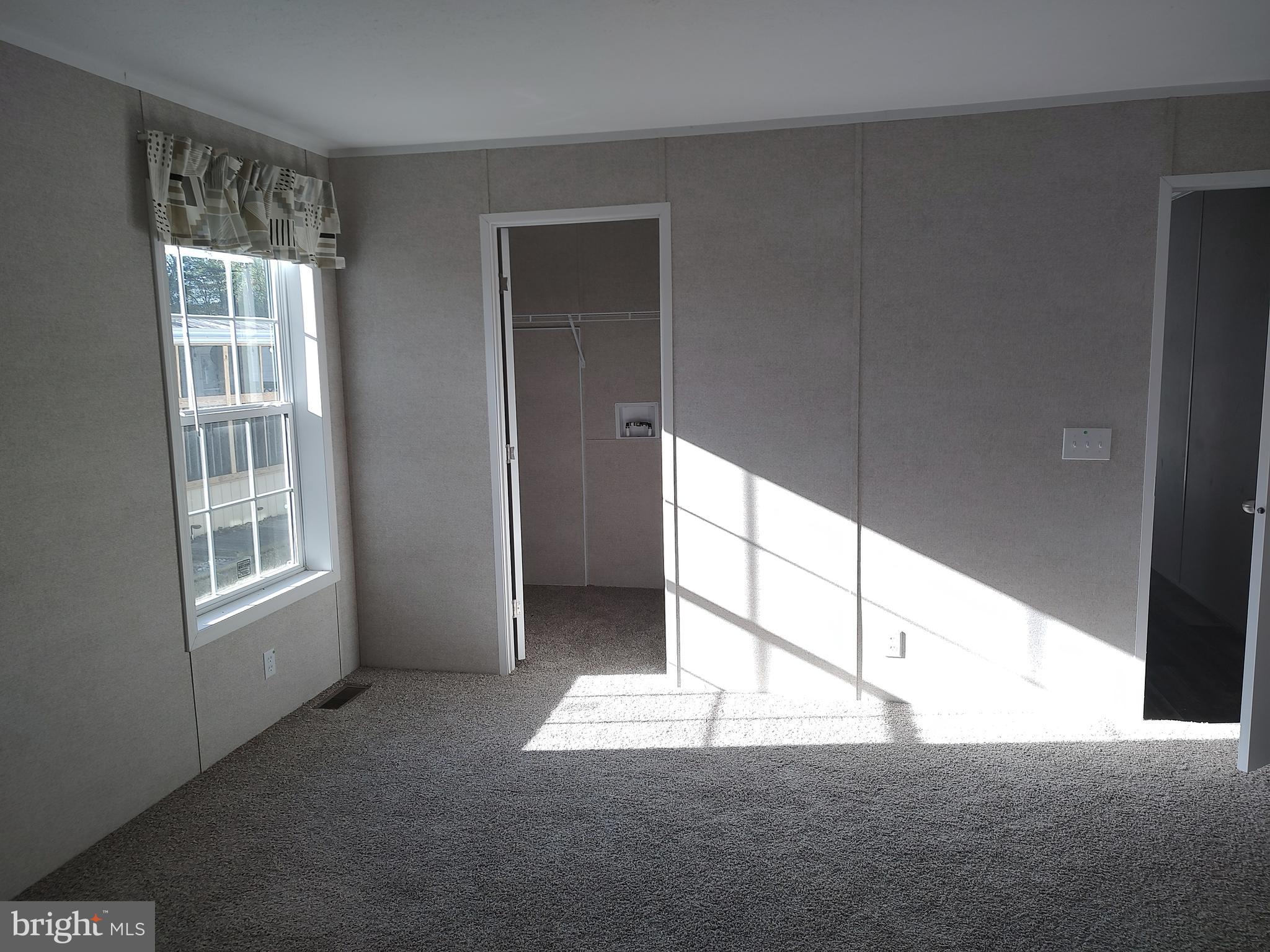 12623 Shell Mill Road, Unit 51 Bishopville, MD 21813 - Photo 28 of 41 a view of an empty room and window
