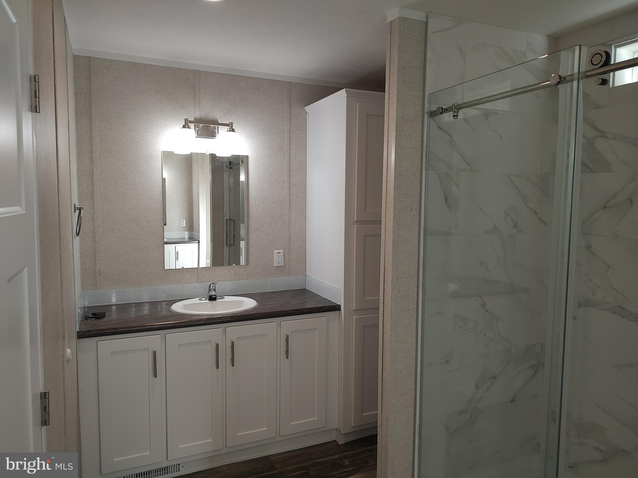 12623 Shell Mill Road, Unit 51 Bishopville, MD 21813 - Photo 33 of 41 a bathroom with a double vanity sink and a mirror