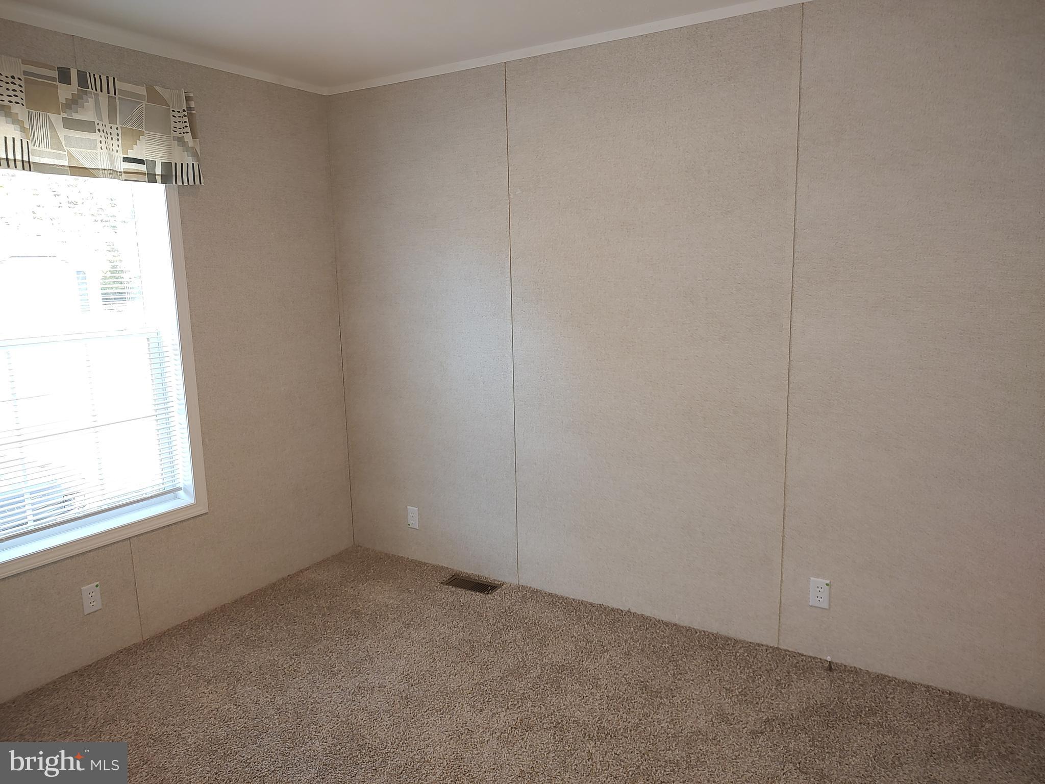 12623 Shell Mill Road, Unit 51 Bishopville, MD 21813 - Photo 36 of 41 a view of an empty room with a window