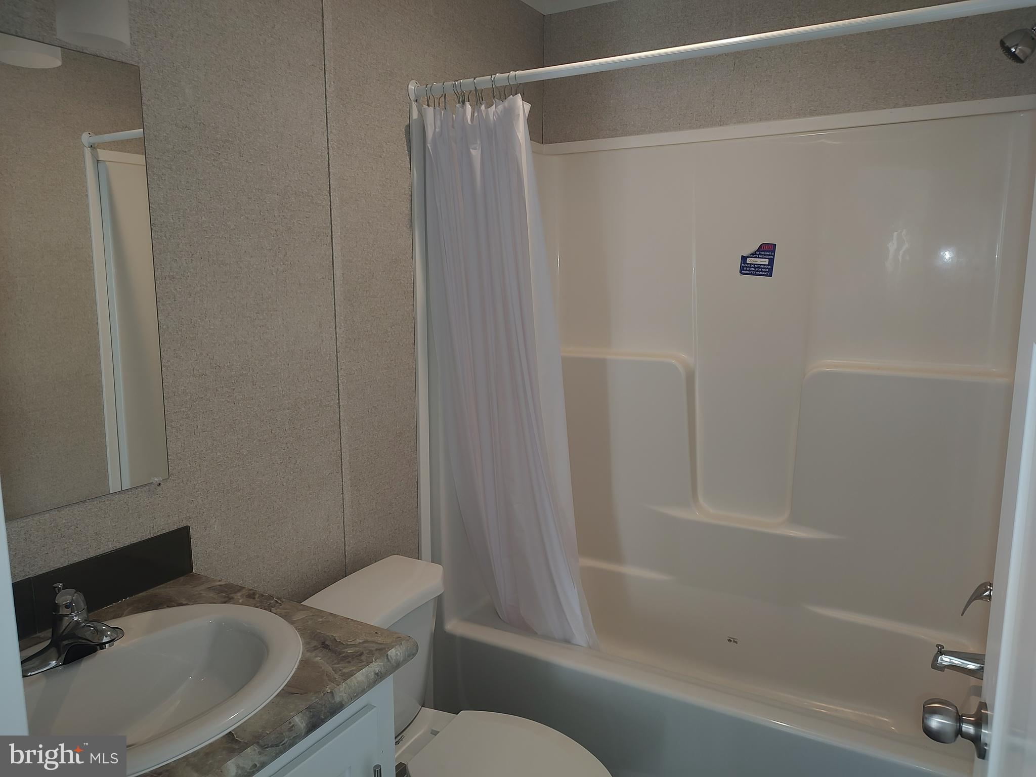 12623 Shell Mill Road, Unit 51 Bishopville, MD 21813 - Photo 37 of 41 a bathroom with a sink and a mirror