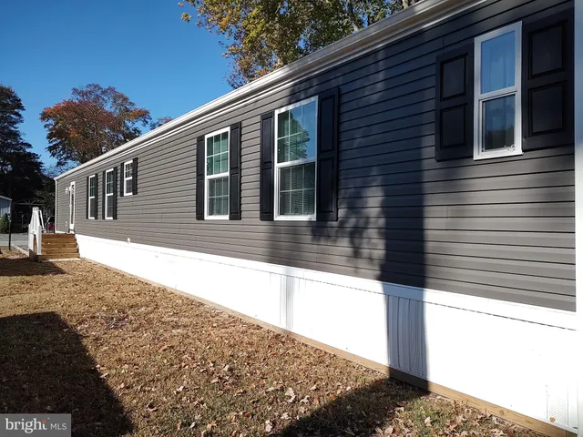 a view of a house with snow on the road