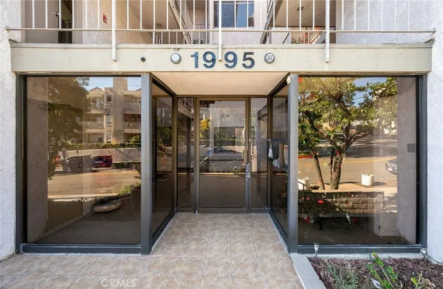 a bathroom with a granite countertop sink a mirror and shower