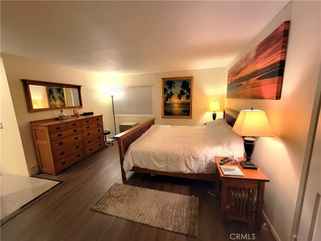 a view of a hallway with kitchen and chandelier