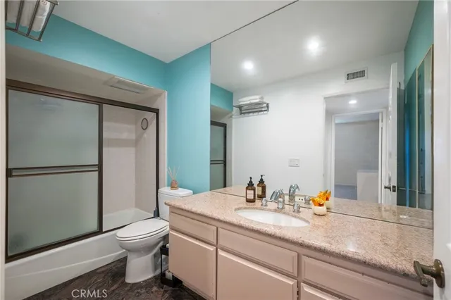 a room with a dresser and a window