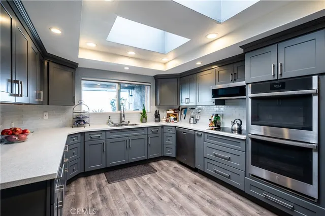 a kitchen with sink cabinets and microwave