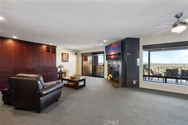 a living room with furniture gym equipment and a large window