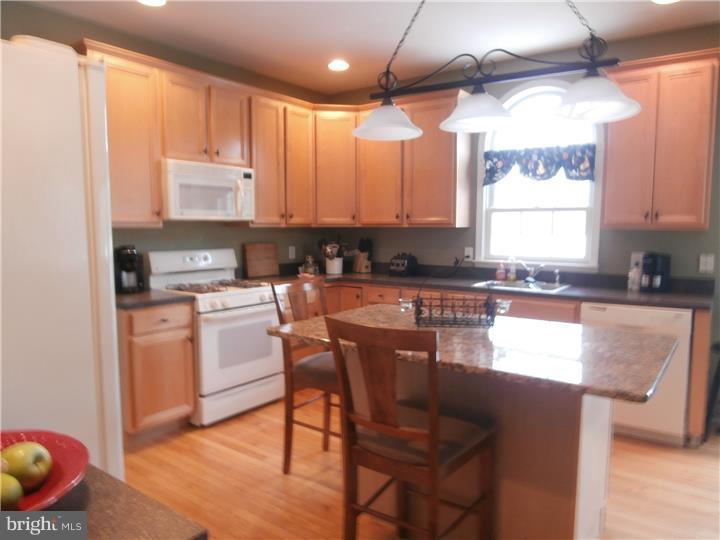 90 Willow Grove Road Shamong, NJ 08088 - Photo 8 of 17 a kitchen with stainless steel appliances granite countertop a stove a sink a microwave a refrigerator and cabinets