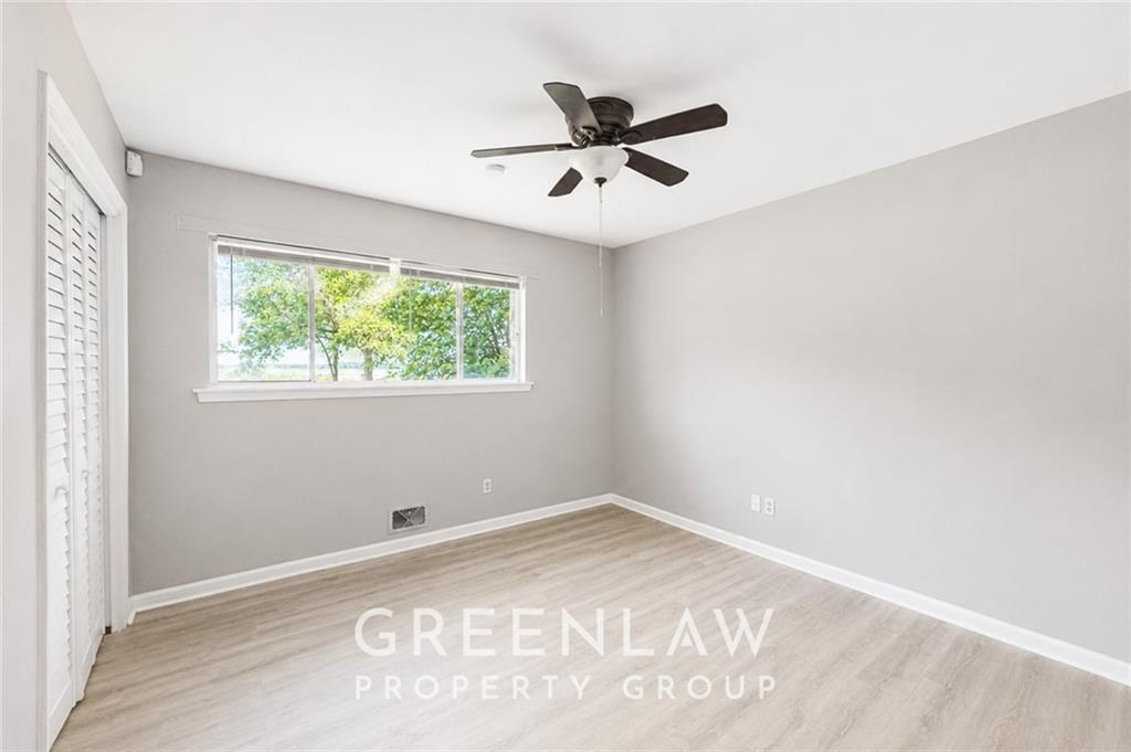 3605 Flat Shoals Road Atlanta, GA 30349 - Photo 22 of 35 a view of a big room with wooden floor closet and windows