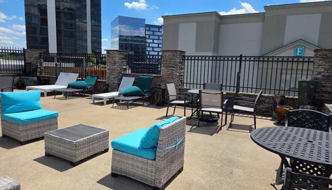 a outdoor space with patio couch and a fireplace