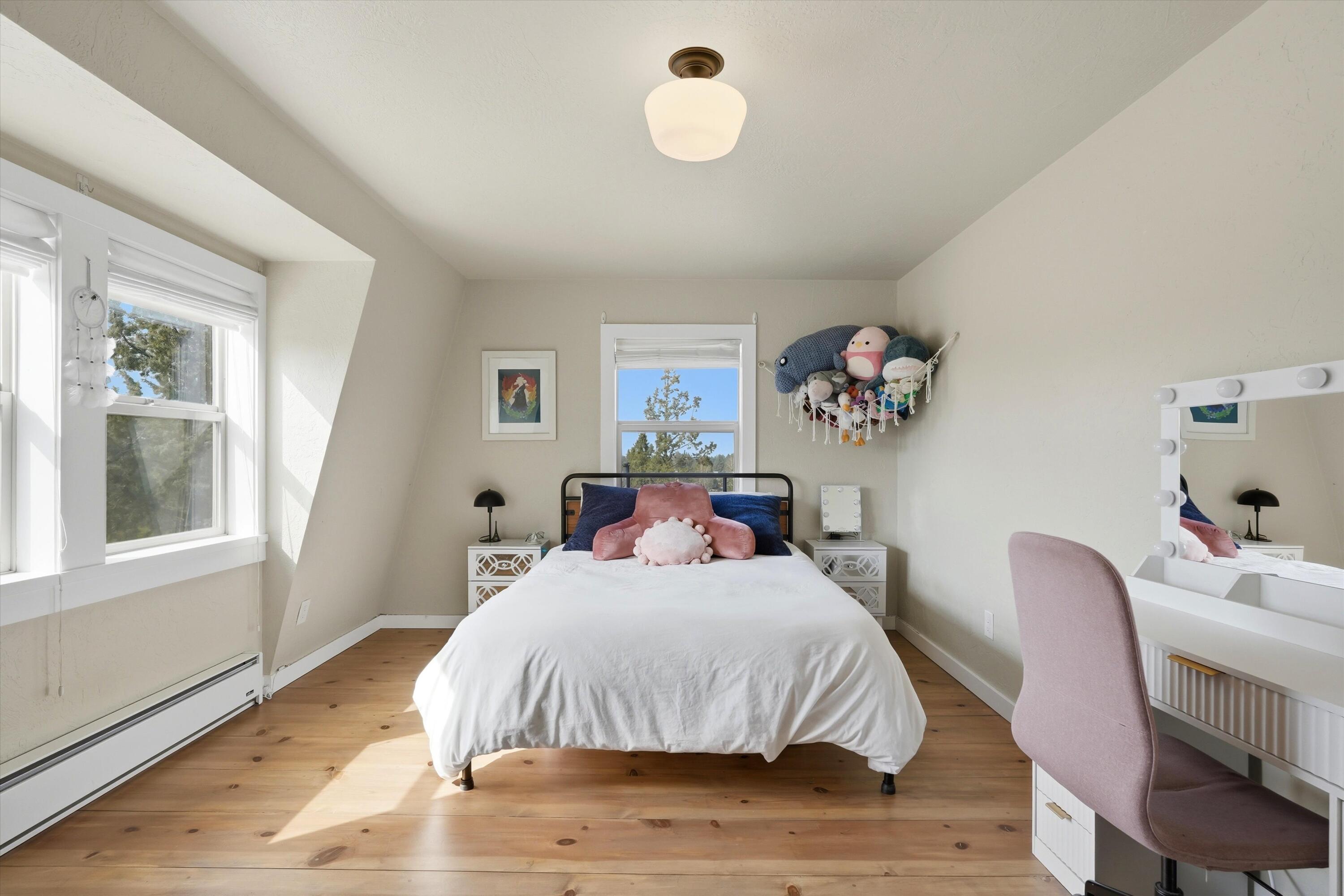 61280 Larsen Road Bend, OR 97702 - Photo 22 of 58 a bedroom with a bed and a window
