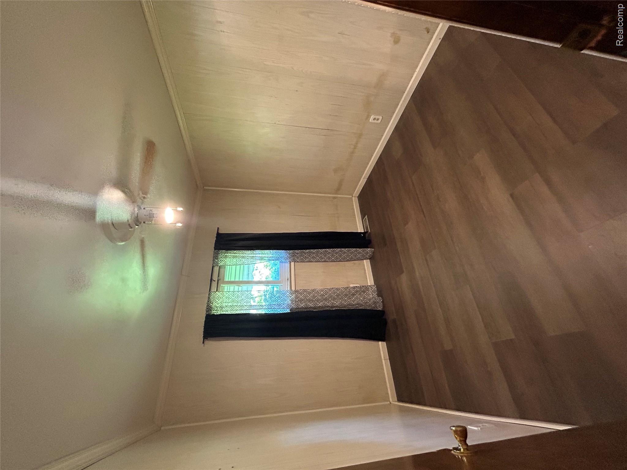 31263 Hayes Road Warren, MI 48088 - Photo 16 of 27 Spare room with dark wood-type flooring, ornamental molding, and a ceiling fan
