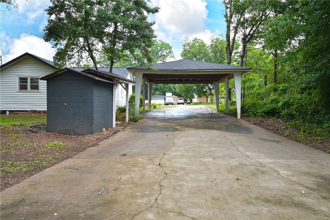 115 Stancil Road Anderson, SC 29625 - Photo 27 of 35 Concrete driveway leads to a covered carport, offering convenient off-street parking and shelter.