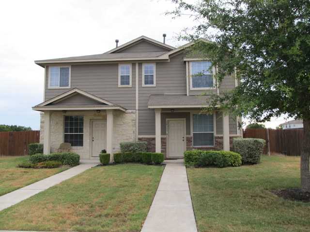 14113 Harris Ridge Boulevard, Unit A& Pflugerville, TX 78660 - Photo 1 of 1 a front view of a house with a yard and potted plants