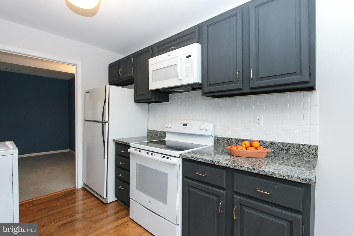 6720 Hillandale Road, Unit 15 Chevy Chase, MD 20815 - Photo 6 of 26 Kitchen w/subway tile and granite tops!