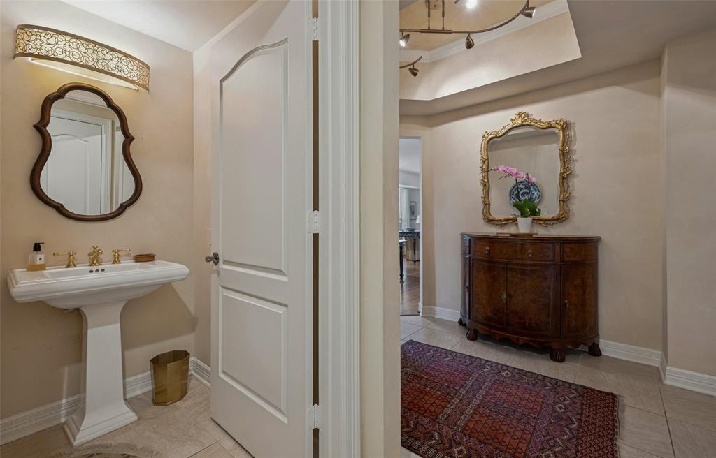 3401 Lee Parkway, Unit 2106 Dallas, TX 75219 - Photo 22 of 34 a bathroom with a sink and a mirror