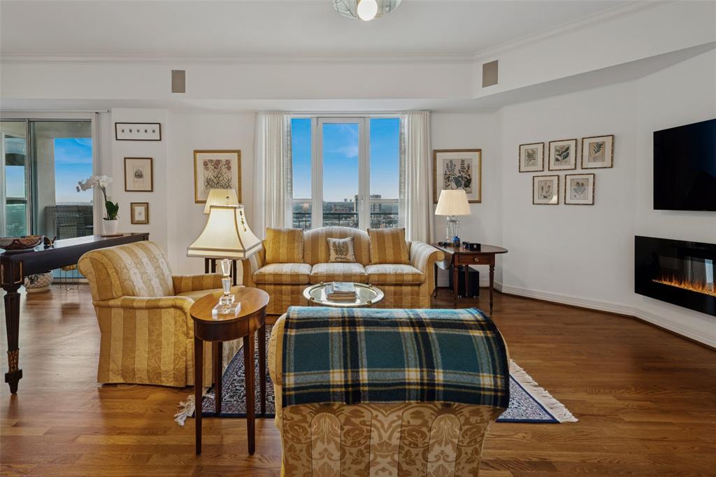 3401 Lee Parkway, Unit 2106 Dallas, TX 75219 - Photo 3 of 34 a living room with furniture and a fireplace