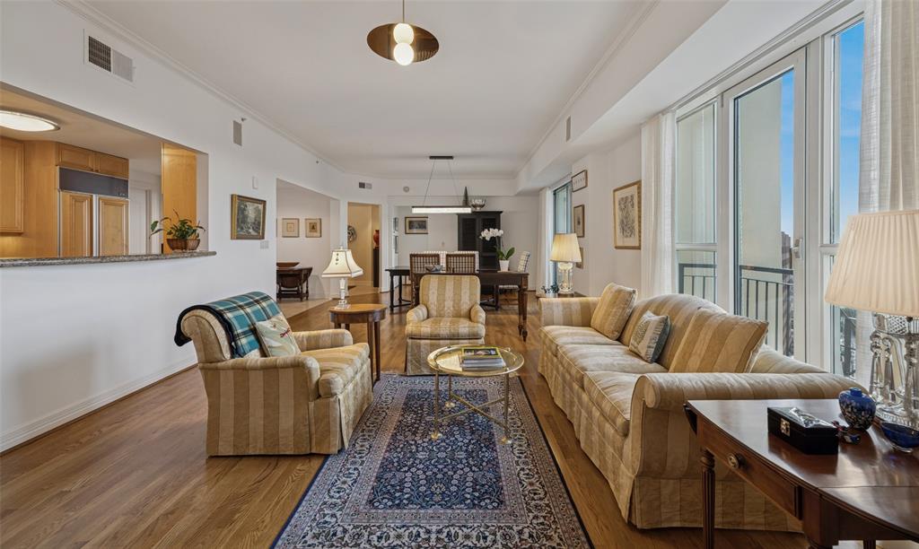 3401 Lee Parkway, Unit 2106 Dallas, TX 75219 - Photo 4 of 34 a living room with furniture wooden floor and a large window