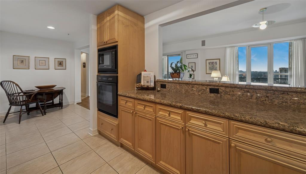 3401 Lee Parkway, Unit 2106 Dallas, TX 75219 - Photo 8 of 34 a large kitchen with granite countertop a sink and cabinets