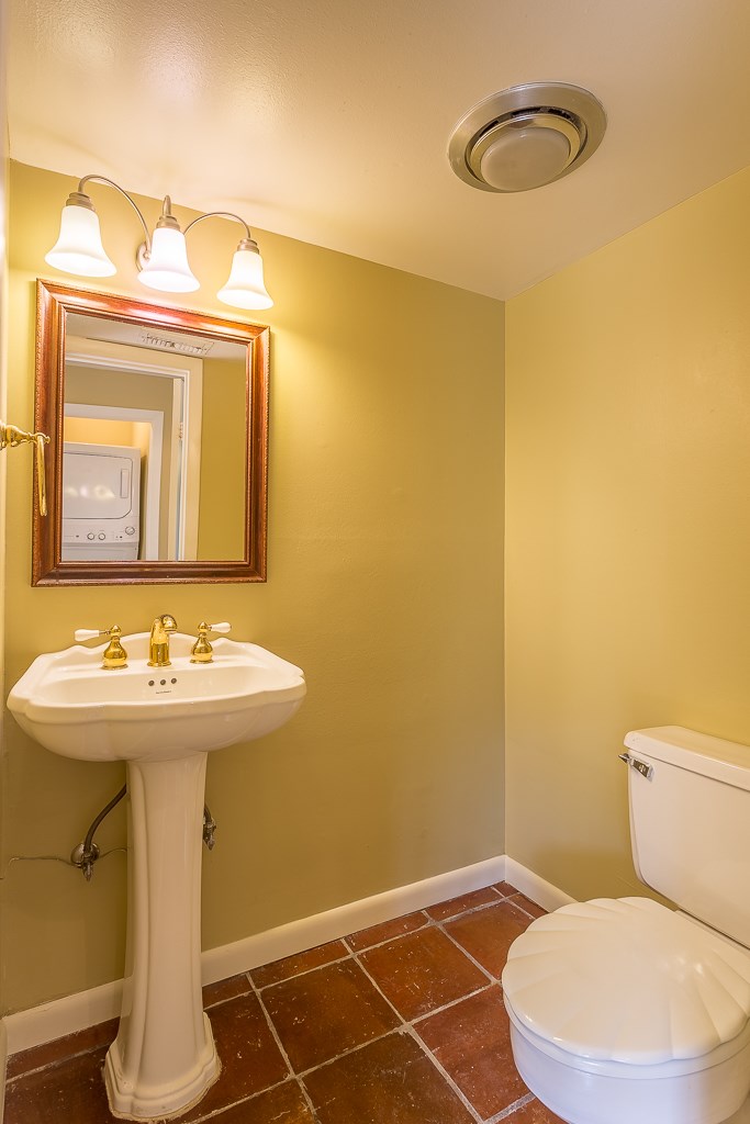 2349 Albans Road, Unit 2 Houston, TX 77005 - Photo 24 of 25 Charming powder bath features a classic pedestal sink, elegant lighting, and warm tile flooring, offering both style and function in a cozy space.