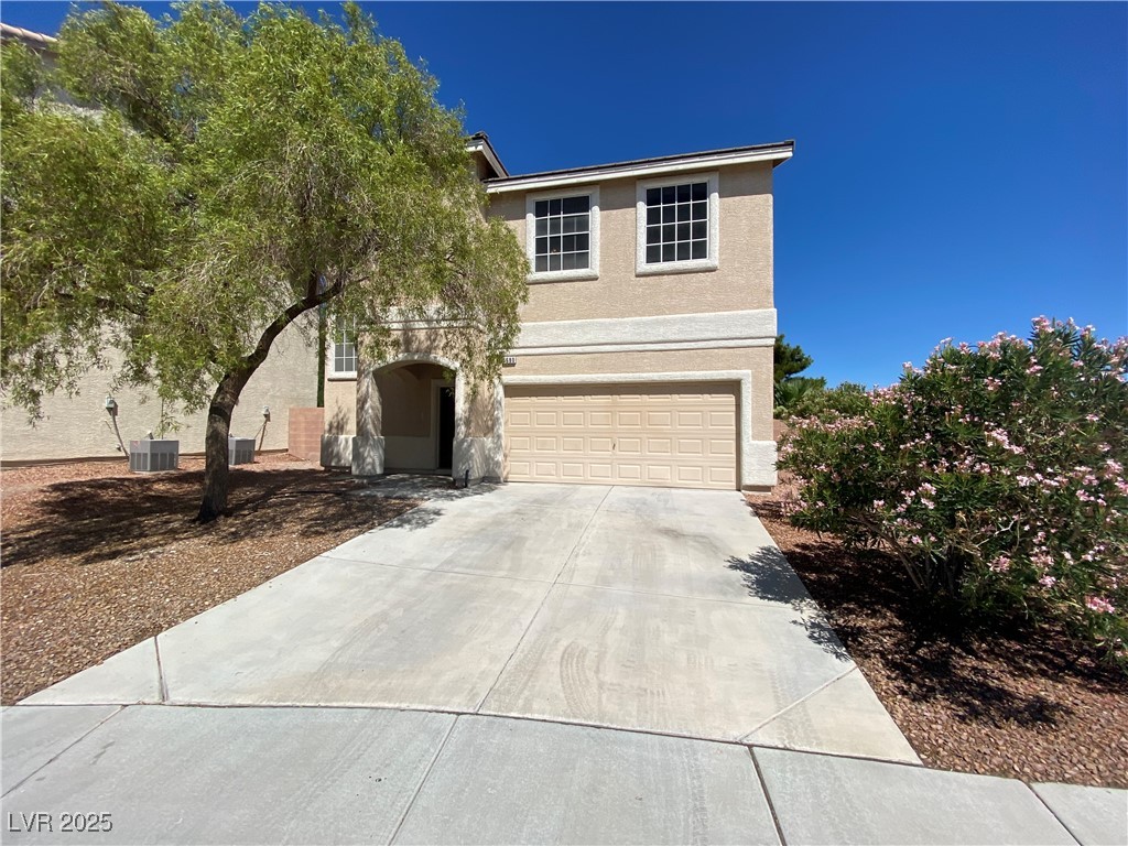 5680 Arrow Tree Street Las Vegas, NV 89130 - Photo 1 of 27 View of front of property featuring stucco siding, driveway, and a garage